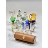 A collection of small decorative glassware, some coloured, including a spirit flask, a nip glass,