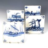 Four blue and white Dutch Delft tiles, decorated with various scenes including a flute playing