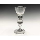 An early 18th century heavy baluster wine glass, circa 1710, the funnel bowl with solid base with