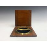 A late 19th century brass circular protractor unmarked, in fitted mahogany case, diameter 14.5cm.