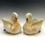 A pair of Staffordshire pottery swan jardinieres, circa 1900, with coloured detail, length 28cm.
