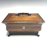 A Regency rosewood, inlaid and chevron banded casket, the bronze handle as clasped hands, the lid