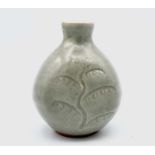 Bernard Howell LEACH (1887-1979) A St Ives celadon glazed stoneware bottle vase, incised with two