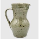 A St Ives standard ware studio pottery jug with celadon glaze, impressed pottery seal, height