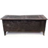 A carved oak sword chest dated 1664, height 54.5cm, width 123cm, depth 37cm.