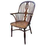 A yew wood and elm Windsor elbow chair, circa 1800, the hooped spindle filled back with pierced