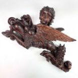 A 17th century carved walnut figural pediment in the form of a sphinx, height 36cm, width 58cm,