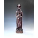 A carved oak figure of Saint Barbara, Northern France, late 15th century, the robed figure holding a