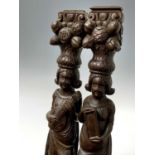 A pair of oak caryatids, circa 1800, carved with standing figures, one playing a lute, above