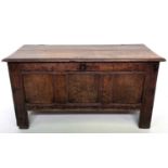 An oak coffer, 18th century, of small proportions, with a triple panelled front and long stile feet,