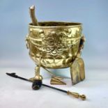 A Victorian brass log bucket, of circular form, the floral embossed body with lions mask handles, on