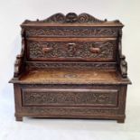 A Victorian carved oak hall bench, height 115cm, width 128cm, depth 48cm.Some movement of the back