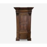 A Continental oak hall cupboard, late 18th century, with a deep moulded cornice above a panelled