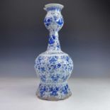 A Dutch Delft pottery vase, 18th century, decorated with cherubs amongst foliage, height 43cm, width