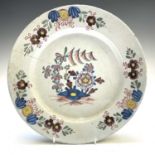 An English Delft polychrome plate, mid 18th century, painted to the centre with a rock and
