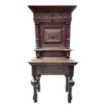 A Flemish carved oak cabinet on stand, 17th century and later, with ebony inlaid decoration,