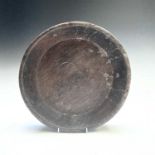 A Welsh oak circular shallow bowl, early 19th century, height 6cm, diameter 32.5cm.