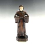 A carved oak figure of a Dutch peasant, 19th century, height 20cm, width 8cm.