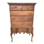 A George III oak chest on stand, with two short and three long drawers, the lower part with three