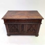 An oak coffer, with 16th century panels, height 52cm, width 80cm, depth 44.4cm.Provenance: From