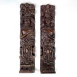 A pair of 17th Century oak panels carved with Atlantes, surmounted by scrolling whorls, 48cms x