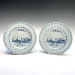 A pair of 18th century Delft blue and white plates, each decorated with a figure in a landscape,