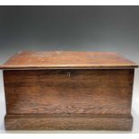 A 19th century oak blanket box, of small proportions, the hinged cover opening to reveal a candle