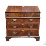 An early 18th century walnut veneered bureau, the fall front opening to reveal a fitted interior