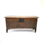 A late 17th century oak six plank coffer, with a rectangular moulded top, the front carved with a