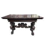 A 17th century style oak dining table, the legs carved with mythical creatures and rams heads,