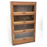 An oak glazed bookcase, 1930s, fitted with four up and over doors, height 154cm, width 89.5cm, depth