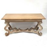 A continental oak rectangular centre table on foliate scroll legs and cross frame stretcher,