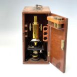 A J.Swift & Son brass monocular microscope, circa 1900, with black lacquered base, numbered FH13032,