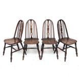 Set four beech and elm dining chairs, the spindle backs with central splats with carved roundels,
