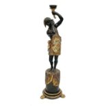 A Blackamoor figural torchere circa 1900 with painted and gilt decoration, modelled standing on