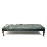 A Victorian mahogany framed day bed couch or Ottoman, with later rexine upholstery and raised on