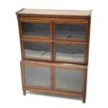 An oak sectional bookcase, early 20th century, the four sections each with a pair of glazed doors,