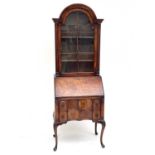 A Queen Anne style walnut bureau bookcase, early 20th century, with domed glazed upper part