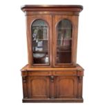 A Victorian mahogany bookcase with moulded cornice, glazed twin doors enclosing three adjustable