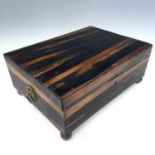 An Indian coromandel wood rectangular casket, the sandalwood and inlaid interior with five lidded