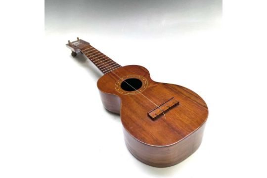 A Kumalae Gold Award Hawaii wood ukulele with carrying