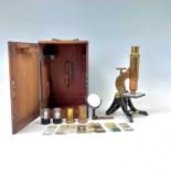 A brass and lacquered microscope, circa 1900, contained in a mahogany case, height 25cm, together