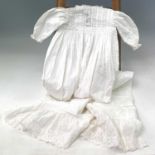 A 19th century cotton child's nightgown together with six other nightgowns and christening robes. (