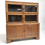 An Art Deco oak sectional bookcase, the three parts each with a pair of hinged glazed doors,