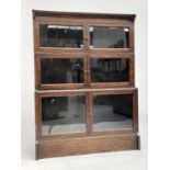 An oak sectional bookcase, 1930s, the three parts each with twin glazed hinged doors, height