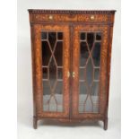 An 18th century Dutch marquetry cabinet with a single drawer above twin astragal glazed doors