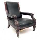 A Victorian library mahogany armchair with carved lion mask detail on tapering reeded legs and