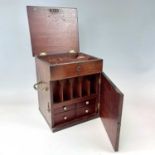 A 19th century home apothecary cabinet, with rising lid and hinged door containing compartments