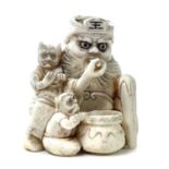 A Japanese Meiji period carved ivory netsuke depicting a figure with sake jar attended by two uni,