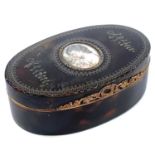 An early 19th century tortoiseshell oval snuff box, the hinged lid with silver inlay and an oval